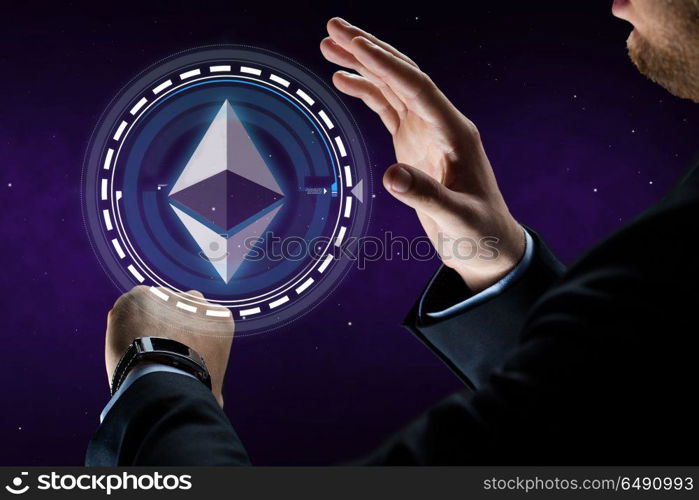 business, cryptocurrency and future technology concept - close up of businessman hands with smart watch hand ethereum hologram over ultra violet space background. male hands with smart watch and ethereum hologram. male hands with smart watch and ethereum hologram