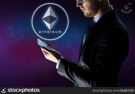 business, cryptocurrency and future technology concept - close up of businessman with transparent smartphone and virtual ethereum symbol hologram over ultra violet space background. businessman with smartphone and ethereum hologram. businessman with smartphone and ethereum hologram