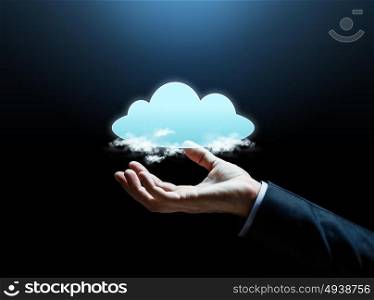 business, cyberspace, technology and people concept - close up of businessman hand with cloud computing icon over dark background. close up of businessman hand