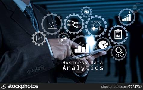 Business data analytics management with connected gear cogs with KPI financial charts and graph.businessman hand use smart phone computer as concept