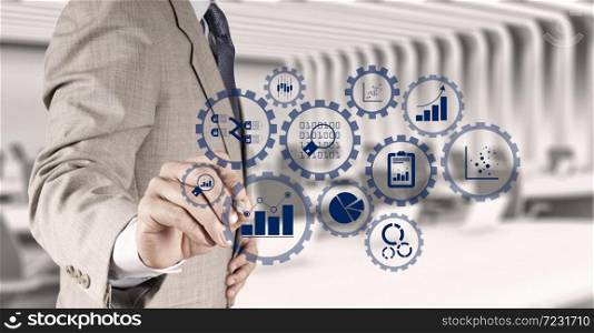 Business data analytics management with connected gear cogs with KPI financial charts and graph.businessman hand writing in the whiteboard or virtual screen