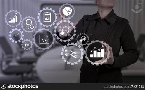 Business data analytics management with connected gear cogs with KPI financial charts and graph.businesswoman with an open hand as showing something concept