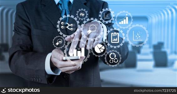Business data analytics management with connected gear cogs with KPI financial charts and graph.businessman hand use smart phone computer with email icon as concept