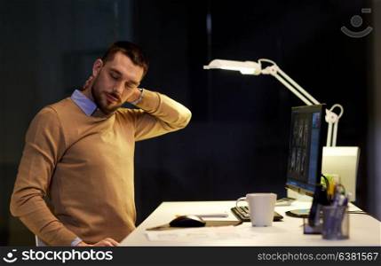 business, deadline and health concept - tired man having neckache working at night office. tired man having neck ache working at night office