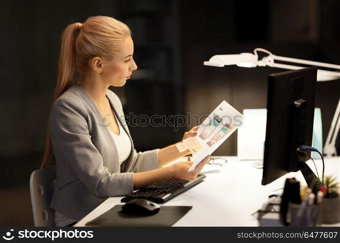 business, deadline and technology concept - businesswoman or web designer with user interface design mockup and computer working at night office. web designer user interface mockup at night office. web designer user interface mockup at night office