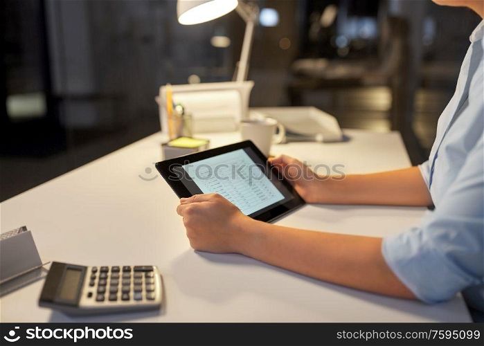 business, deadline and technology concept - businesswoman with open file on tablet pc computer working at night office. businesswoman with tablet computer at night office