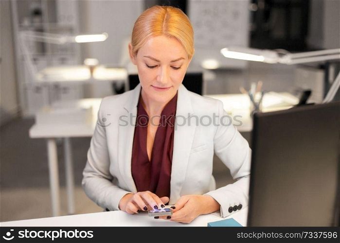 business, deadline and technology concept - businesswoman with smartphone and computer working at night office. businesswoman with smartphone at night office