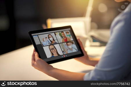 business, deadline and technology concept - businesswoman with tablet pc computer having video call at night office. woman with video call on tablet pc at office