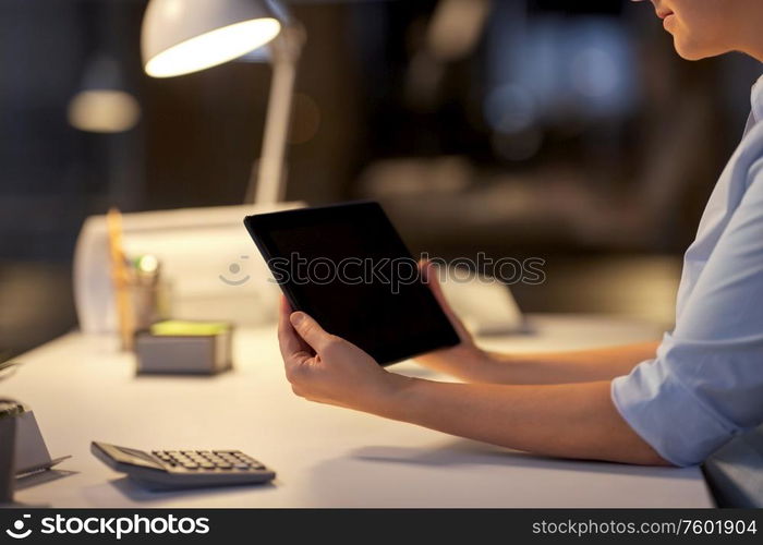 business, deadline and technology concept - businesswoman with tablet pc computer working at night office. businesswoman with tablet computer at night office