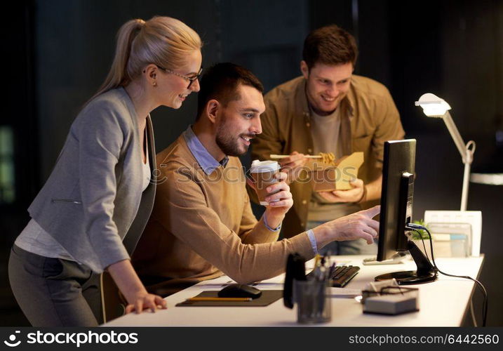 business, deadline and technology concept - coworkers with computer and takeout food and coffee working late at night office. business team with computer working late at office