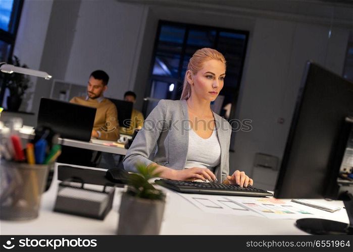 business, deadline and technology concept - designer or user interface developer with computer working at night office. designer working on computer at night office. designer working on computer at night office