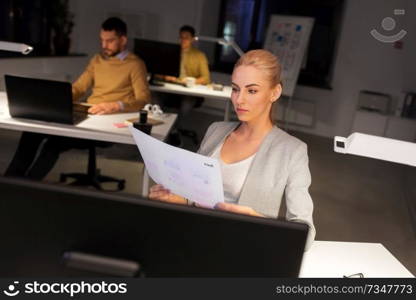 business, deadline and technology concept - designer or user interface developer with papers working at night office. designer working with papers at night office