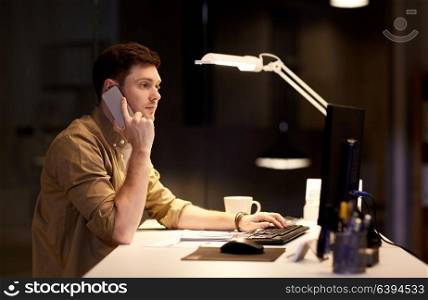 business, deadline and technology concept - man with computer calling on smartphone at night office. man calling on smartphone late at night office