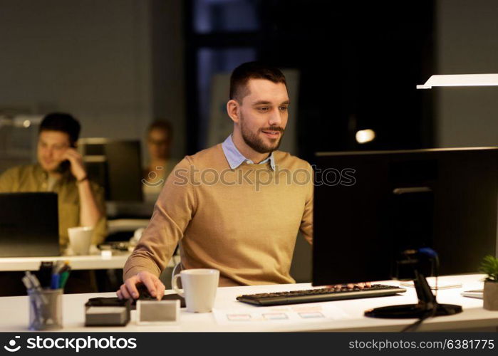 business, deadline and technology concept - man with computer working at night office. man with computer working late at night office