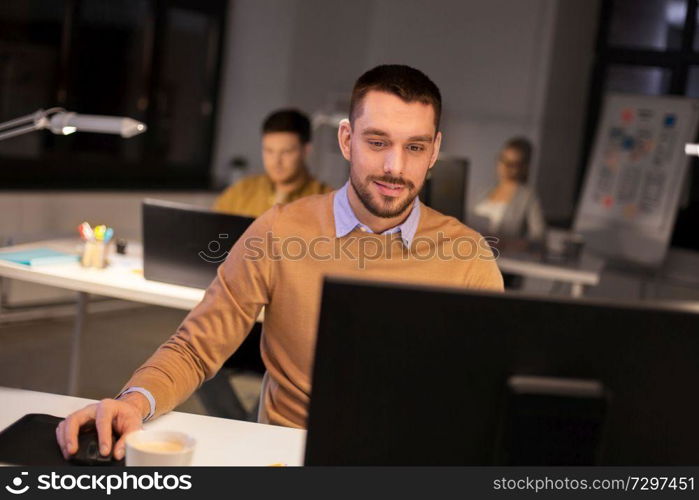 business, deadline and technology concept - man with computer working at night office. man with computer working late at night office