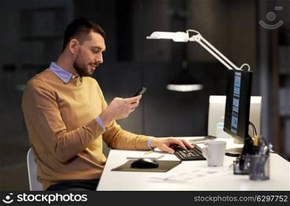 business, deadline and technology concept - man with smartphone and computer working at night office. man with smartphone working late at night office. man with smartphone working late at night office