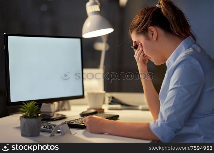 business, deadline and technology concept - stressed businesswoman with computer working at night office. stressed businesswoman with computer at night