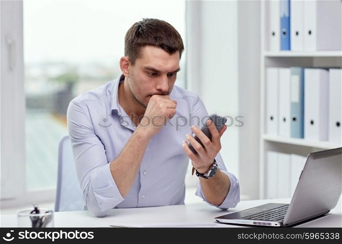 business, deadline, people and technology concept - businessman with smartphone and laptop computer at office