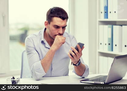 business, deadline, people and technology concept - businessman with smartphone and laptop computer at office