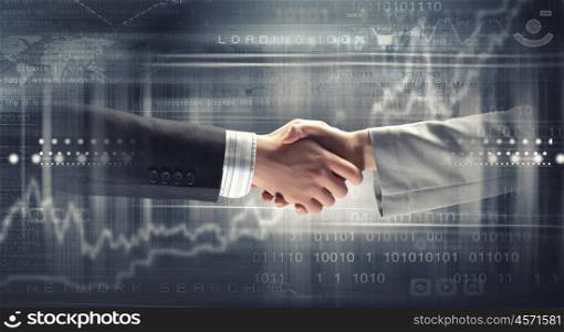 Business deal. Close up of business handshake on digital background