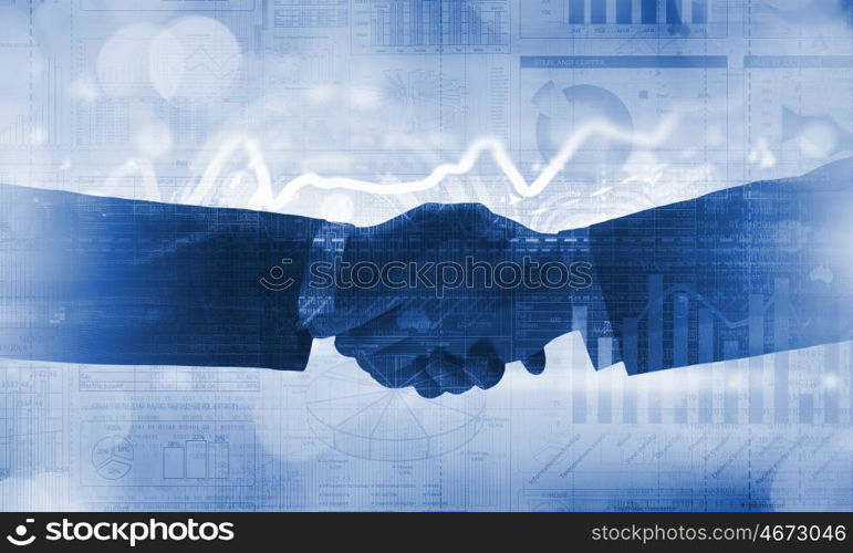 Business deal. Close up of business handshake on digital background