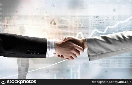 Business deal. Close up of business handshake on digital background