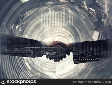 Business deal. Close up of business handshake on digital background