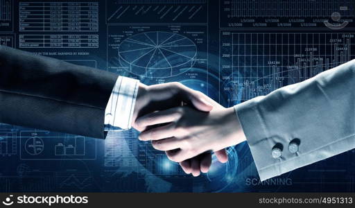 Business deal. Close up of business handshake on digital background