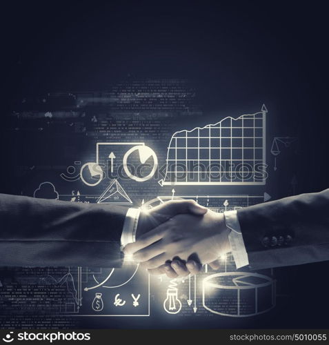 Business deal. Close up of business handshake on digital background