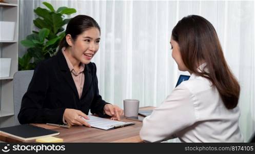 Business deal meeting, young businesswomen carefully reviewing terms and condition of contract agreement papers in office. Corporate lawyer give consultation on contract deal. Enthusiastic. Business deal meeting, businesswomen reviewing terms and condition. Equilibrium