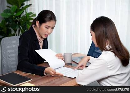 Business deal meeting, young businesswomen carefully reviewing terms and condition of contract agreement papers in office. Corporate lawyer give consultation on contract deal. Enthusiastic. Business deal meeting, businesswomen reviewing terms and condition. Equilibrium