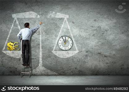 Business deliberation. Businessman on ladder pointing at scale picture
