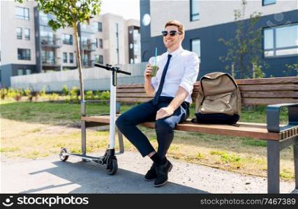 business, detox and people and concept - young businessman with bag and electric scooter sitting on street bench and drinking green smoothie from takeaway plastic cup in city. businessman with scooter drinking smoothie in city