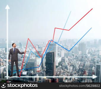 business, development and people concept - smiling man holding graph line over chart and cityscape background