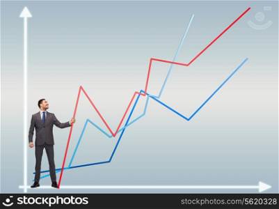 business, development and people concept - smiling man holding graph line over chart background