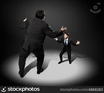 Business dispute. Image of businesspeople arguing and acting as sumo fighters