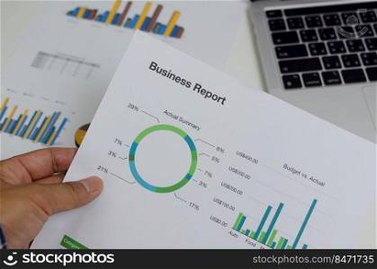 Business document chart report financial and graph statistic analysis management information and research investment plan sale on desk at office.