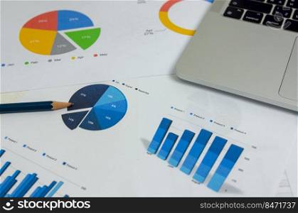 Business document graph finance report statistic analysis and chart investment information with computer laptop on desk at office.
