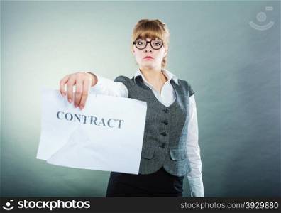Business, documents and legal concept - serious unhappy businesswoman showing crumpled contract