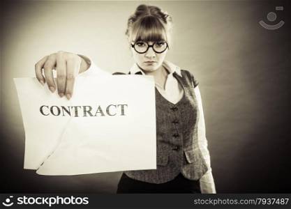 Business, documents and legal concept - serious unhappy businesswoman showing crumpled contract