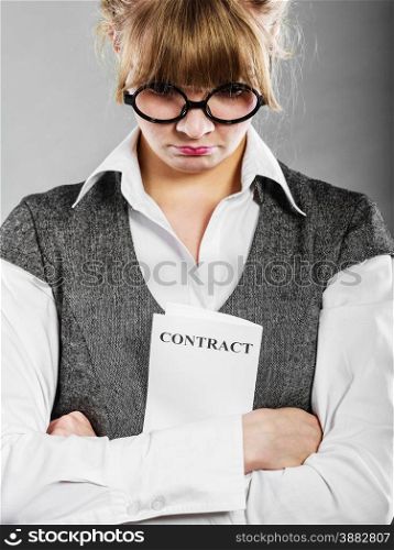 Business documents legal concept - closeup skeptical unhappy businesswoman holding contract in hands. Negative human emotion face expression feeling reaction