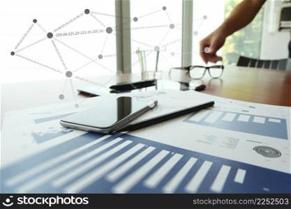 business documents on office table with digital tablet and man working with smart phone in the background with social network diagram concept