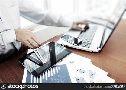 business documents on office table with digital tablet and man working with smart laptop computer background with social network diagram concept 