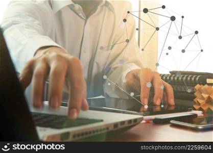 business documents on office table with digital tablet and man working with smart laptop computer background with overcast exposure effect with social media diagram
