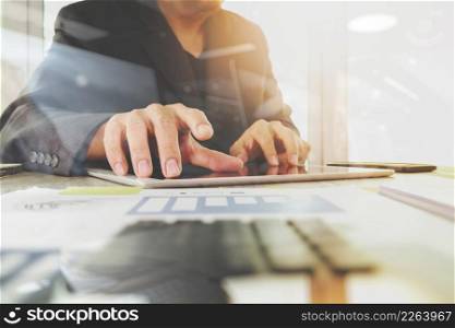 business documents on office table with digital tablet computer with smart phone and graph business diagram and businessman working in the background