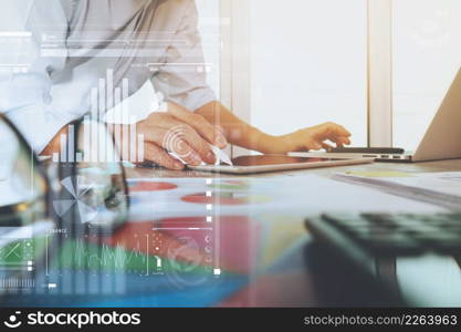 business documents on office table with laptop computer and graph business digital diagram and businessman working in the background