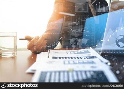 business documents on office table with laptop computer and graph business with social network diagram and man working in the backgroun