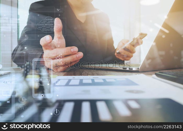 business documents on office table with laptop computer and smart phone and graph business digital diagram and businessman working in the background