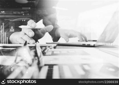 business documents on office table with laptop computer and smart phone and graph business digital diagram and businessman working in the background,black and white