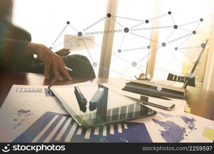 business documents on office table with smart phone and digital tablet and graph business diagram and man working in the background